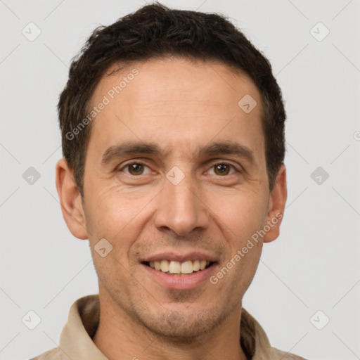 Joyful white adult male with short  brown hair and brown eyes