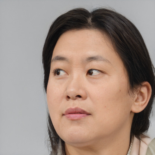 Joyful white adult female with medium  brown hair and brown eyes
