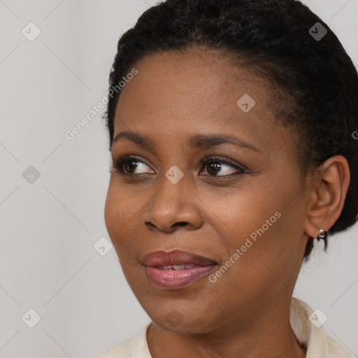 Joyful black young-adult female with short  brown hair and brown eyes