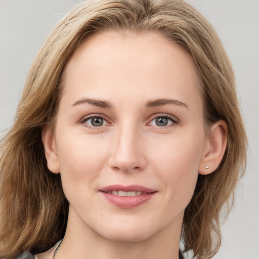 Joyful white young-adult female with medium  brown hair and blue eyes