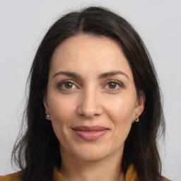 Joyful white adult female with long  brown hair and brown eyes