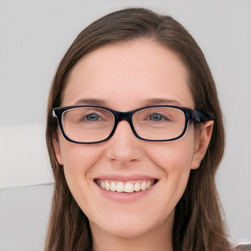 Joyful white young-adult female with long  brown hair and blue eyes