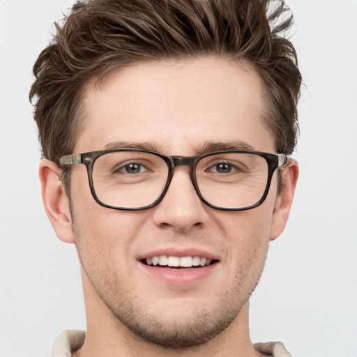 Joyful white young-adult male with short  brown hair and grey eyes