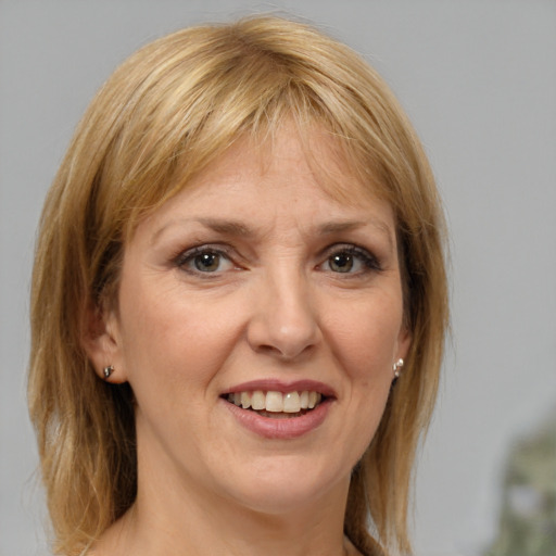 Joyful white adult female with medium  brown hair and brown eyes