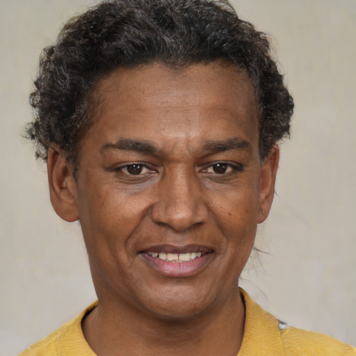 Joyful black adult male with short  brown hair and brown eyes