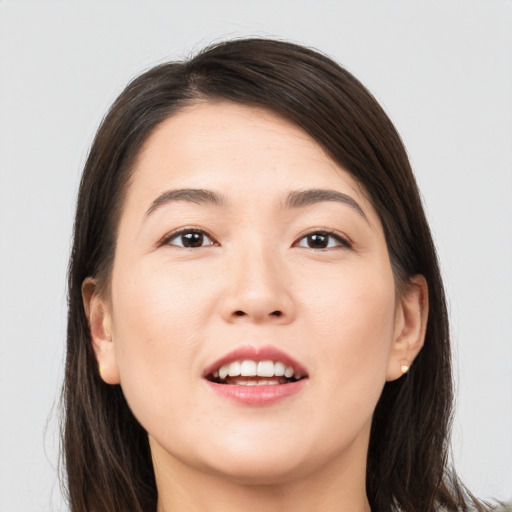 Joyful white young-adult female with long  brown hair and brown eyes