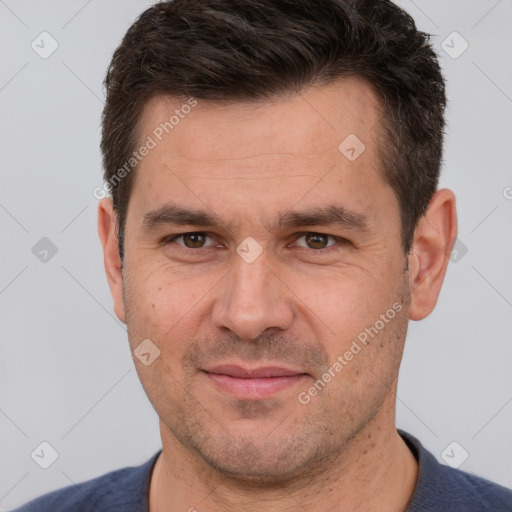 Joyful white adult male with short  brown hair and brown eyes