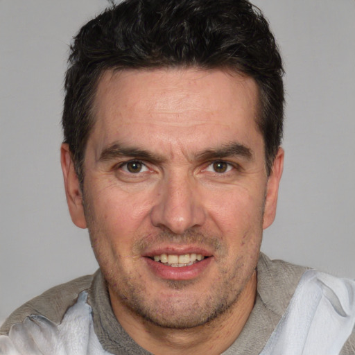 Joyful white adult male with short  brown hair and brown eyes