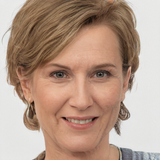 Joyful white adult female with medium  brown hair and grey eyes