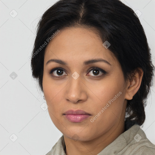 Joyful latino young-adult female with medium  brown hair and brown eyes