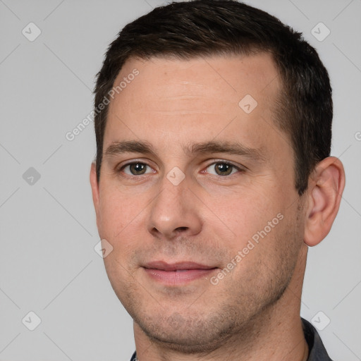 Joyful white adult male with short  brown hair and brown eyes