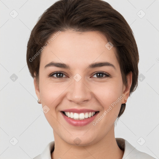 Joyful white young-adult female with short  brown hair and brown eyes