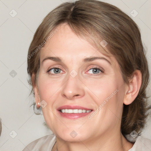 Joyful white adult female with medium  brown hair and blue eyes