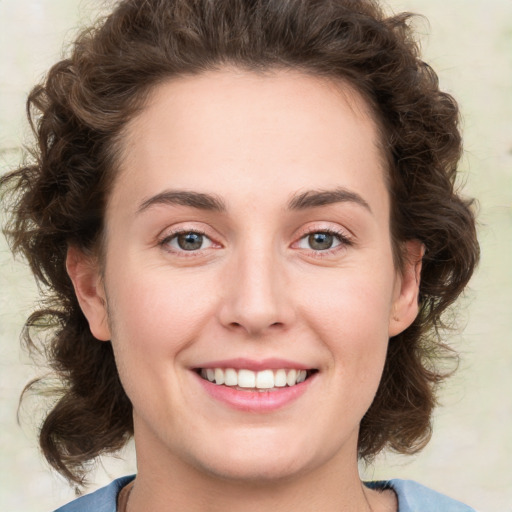 Joyful white young-adult female with medium  brown hair and green eyes