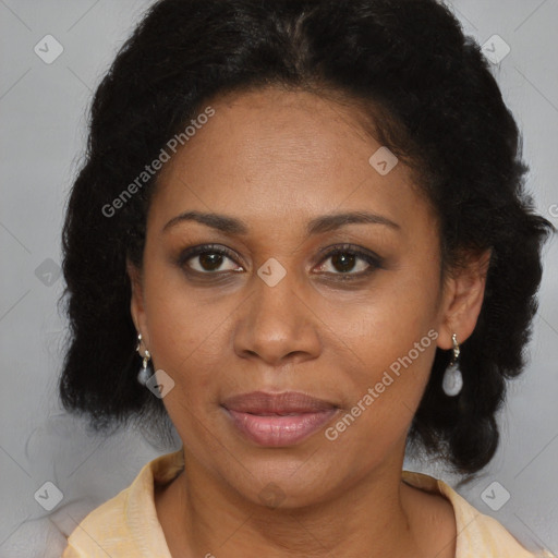 Joyful black adult female with long  brown hair and brown eyes