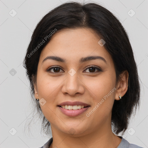 Joyful latino young-adult female with medium  brown hair and brown eyes