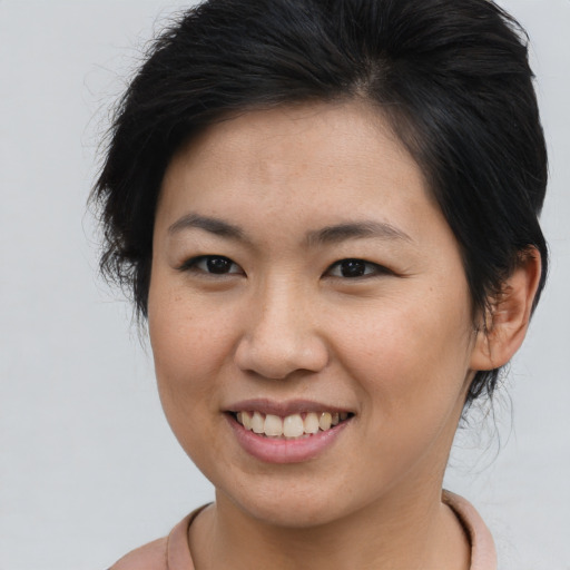Joyful asian young-adult female with medium  brown hair and brown eyes