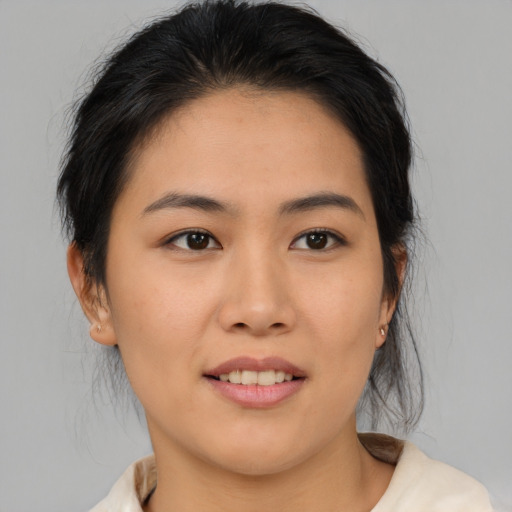Joyful asian young-adult female with medium  brown hair and brown eyes