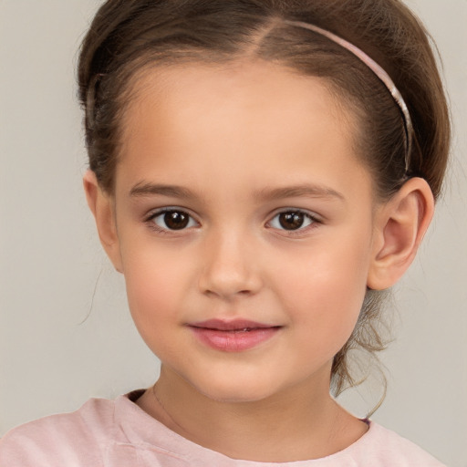 Joyful white child female with short  brown hair and brown eyes