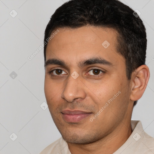 Joyful latino young-adult male with short  black hair and brown eyes