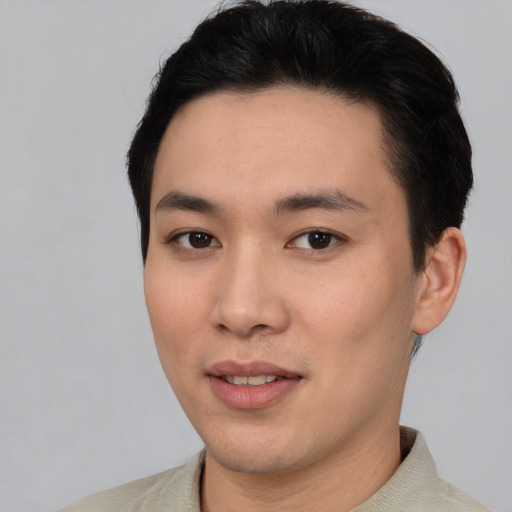 Joyful asian young-adult male with short  black hair and brown eyes