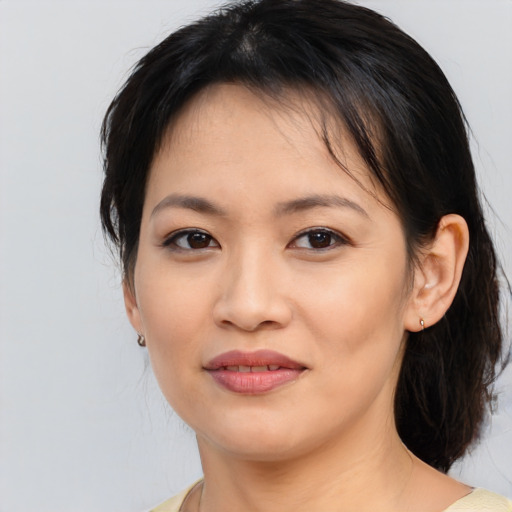 Joyful asian young-adult female with medium  black hair and brown eyes