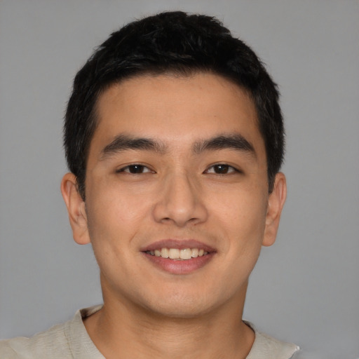 Joyful asian young-adult male with short  brown hair and brown eyes