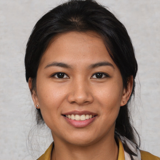 Joyful asian young-adult female with medium  brown hair and brown eyes