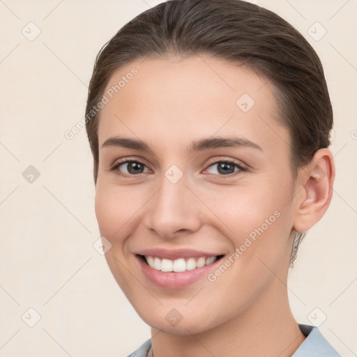 Joyful white young-adult female with short  brown hair and brown eyes