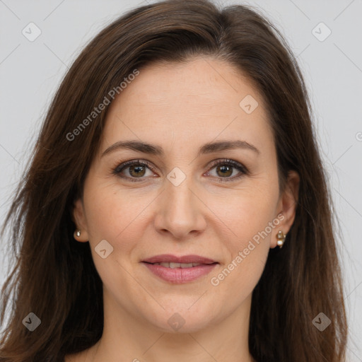 Joyful white adult female with long  brown hair and brown eyes