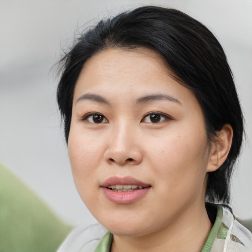 Joyful asian young-adult female with medium  black hair and brown eyes