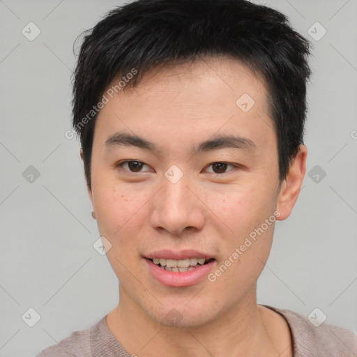 Joyful asian young-adult male with short  brown hair and brown eyes