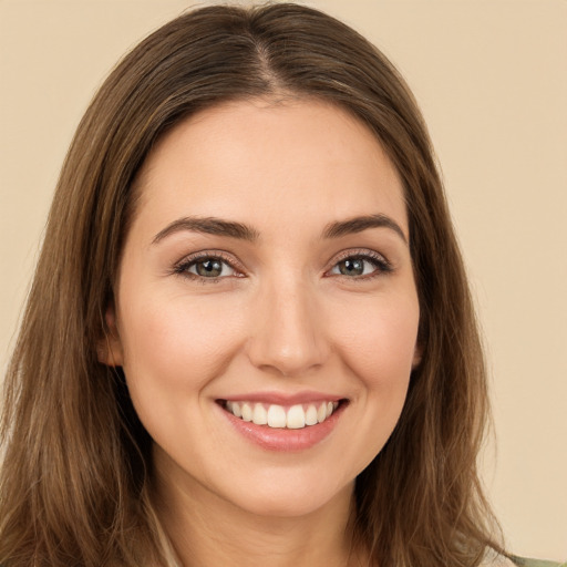 Joyful white young-adult female with long  brown hair and brown eyes