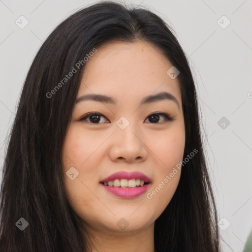 Joyful asian young-adult female with long  brown hair and brown eyes