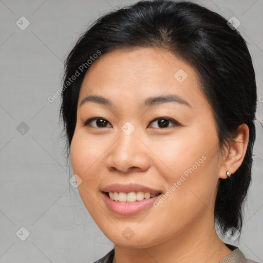 Joyful asian young-adult female with medium  brown hair and brown eyes