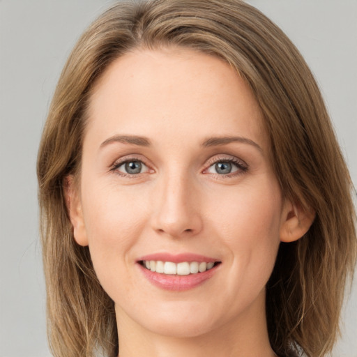 Joyful white young-adult female with long  brown hair and green eyes