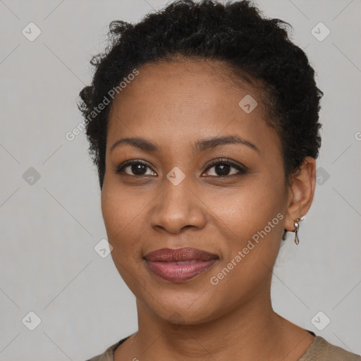 Joyful black young-adult female with short  brown hair and brown eyes