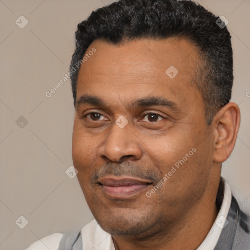 Joyful latino adult male with short  black hair and brown eyes