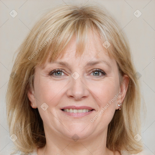 Joyful white adult female with medium  brown hair and blue eyes