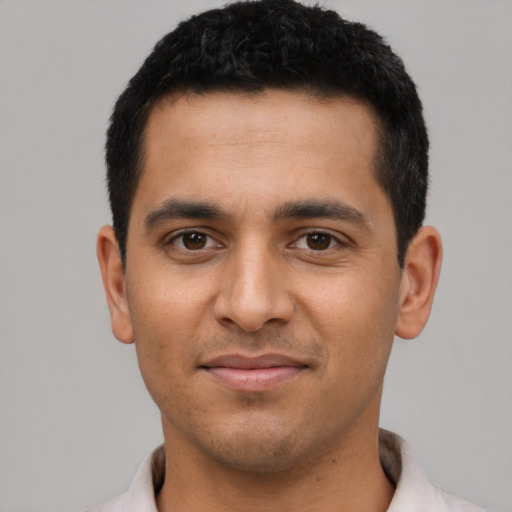 Joyful latino young-adult male with short  brown hair and brown eyes