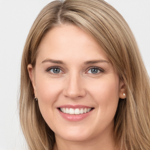 Joyful white young-adult female with long  brown hair and grey eyes