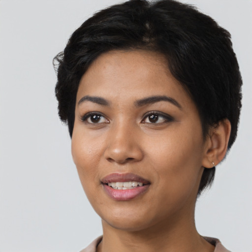 Joyful latino young-adult female with short  black hair and brown eyes
