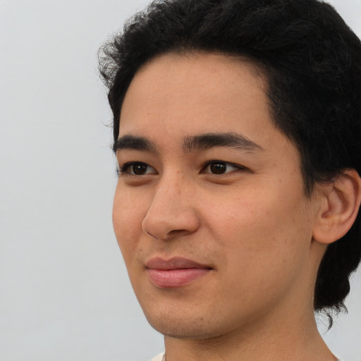 Joyful asian young-adult male with short  black hair and brown eyes