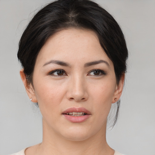 Joyful asian young-adult female with medium  brown hair and brown eyes