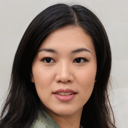 Joyful asian young-adult female with long  black hair and brown eyes