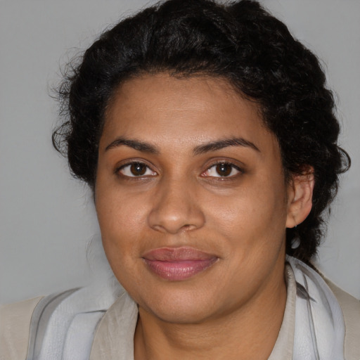Joyful black young-adult female with medium  brown hair and brown eyes
