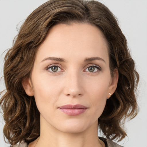 Joyful white young-adult female with medium  brown hair and green eyes