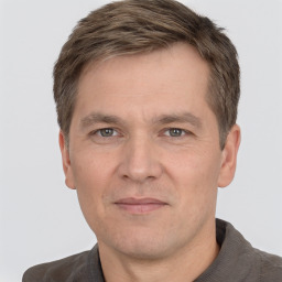 Joyful white adult male with short  brown hair and grey eyes