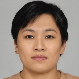 Joyful asian young-adult female with short  brown hair and brown eyes