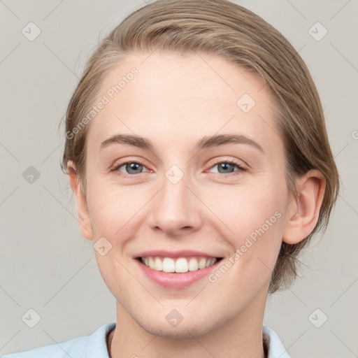 Joyful white young-adult female with medium  brown hair and grey eyes